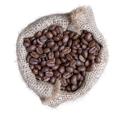 Roasted coffee beans in sackcloth bag isolated on whiteの写真素材