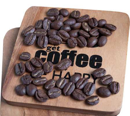 Roasted coffee beans and coffee text on wood tray isolated on whiteの写真素材