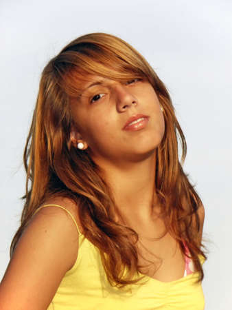 Portrait of a young teenager girl with a yellow t-shirtの写真素材