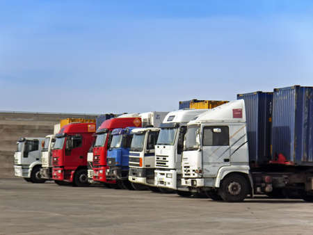 Float of lorries waiting to unload in the pier                                                      ...