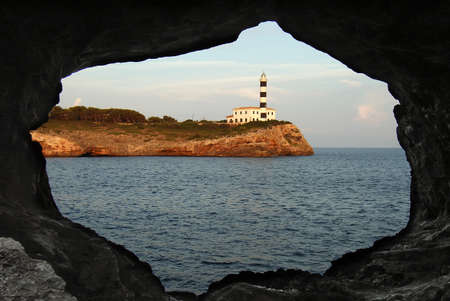 Lighthouse in Porto Colom, seen from a caveの写真素材