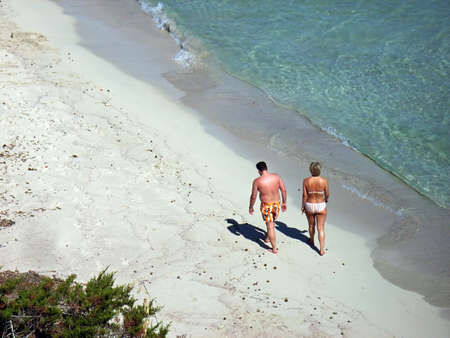 People walking along a beach in Majorca                                                               の写真素材