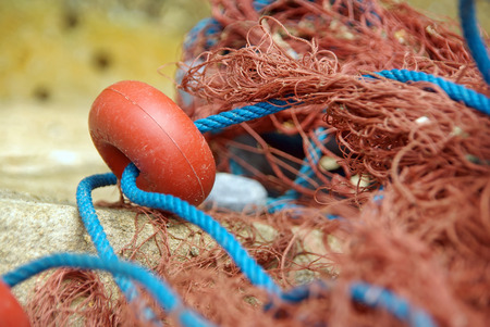 Closeup detail of a red fishing net used in Majorcaの写真素材