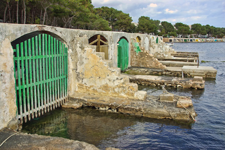 Typical fishermen boat shelters in Porto Colom (Felanitx - Majorca - Balearic Islands - SPAIN)の写真素材