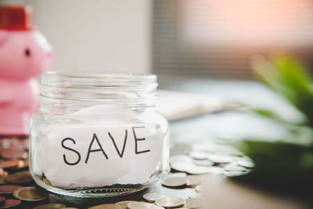 Coins in glass jar for money saving financial concept. business, investment, retirement, finance and...