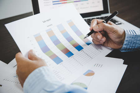 Business woman looking at charts, spreadsheets, graph financial development, bank accounts,...