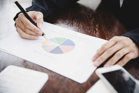 Businessman looking at charts, spreadsheets, graph financial development, bank accounts, statistics, economy, data analysis, investment analysis, stock exchangeの写真素材