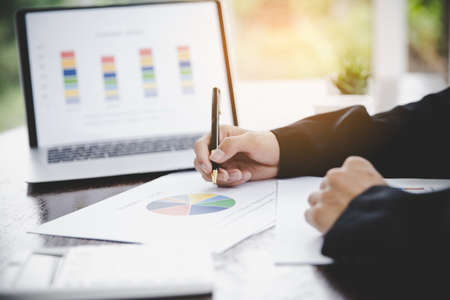 Businessman looking at charts, spreadsheets, graph financial development, bank accounts, statistics, economy, data analysis, investment analysis, stock exchangeの写真素材