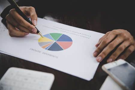Businessman looking at charts, spreadsheets, graph financial development, bank accounts, statistics, economy, data analysis, investment analysis, stock exchangeの写真素材