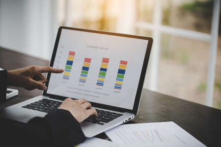 Financial analyst analysis business financial report on laptopの写真素材