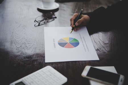 Businessman looking at charts, spreadsheets, graph financial development, bank accounts, statistics,...