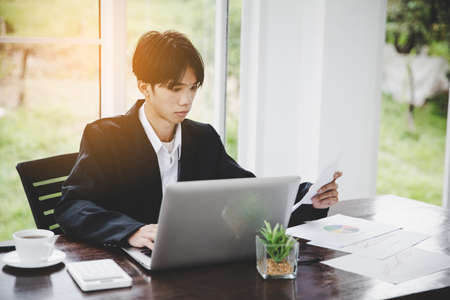Financial analyst analysis business financial report on laptopの写真素材