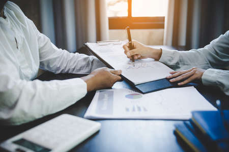 Business adviser analyzing financial figures denoting the progress in the work of the company Design Ideas Concept.の写真素材