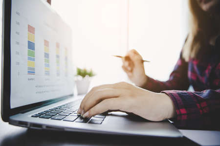 Businesswoman looking at charts, spreadsheets, graph financial development, bank accounts,...