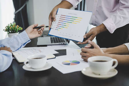 Business people group looking at charts, spreadsheets, graph financial development, bank accounts, statistics, economy, data analysis, investment analysis, stock exchangeの写真素材