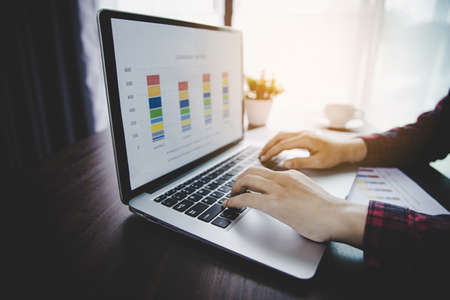 Businesswoman looking at charts, spreadsheets, graph financial development, bank accounts, statistics, economy, data analysis, investment analysis, stock exchangeの写真素材