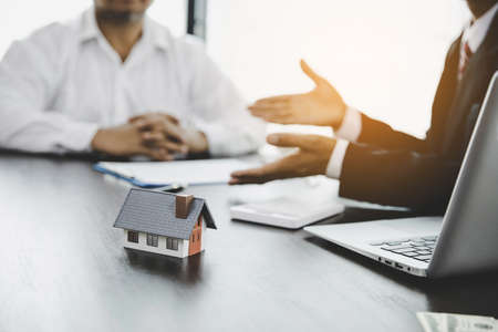 Real estate agent talked about the terms of the home purchase agreement and asked the customer to sign the documents to make the contract legally, Home sales and home insurance concept.の写真素材