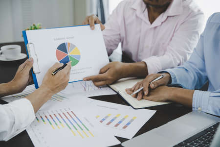 Business people group looking at charts, spreadsheets, graph financial development, bank accounts, statistics, economy, data analysis, investment analysis, stock exchangeの写真素材