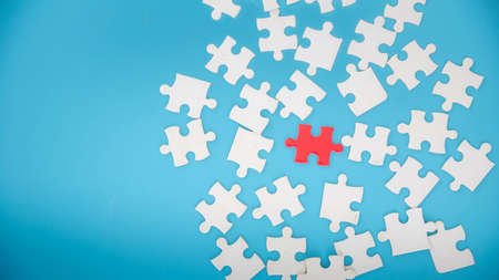 Unfinished white jigsaw puzzle pieces on blue background, The last piece of jigsaw puzzle, Copy...