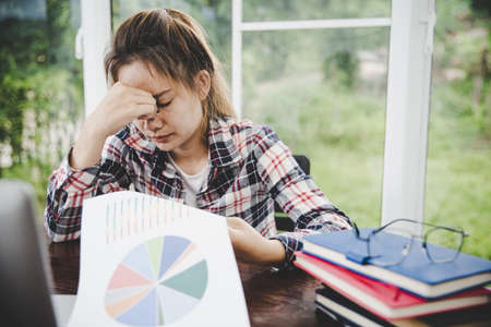 woman stress from work overload,She stressed because must send work At the specified time,Young secretary tired from boss about new projectの写真素材