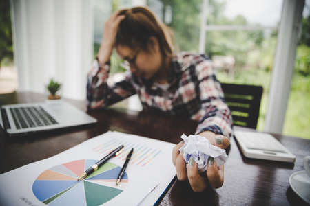 Tired businesswoman working on a computer Portrait of stressed young woman comfortably with headache...
