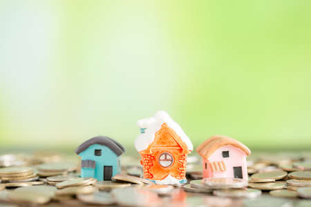 Mini house on coins, Savings money for buy house and loan to business investment for real estate concept.の写真素材
