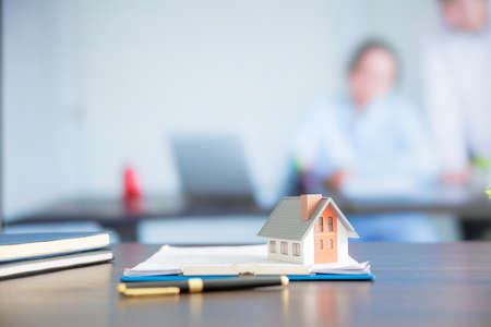 House model on wooden table in office with copy space, real estate concept.の写真素材