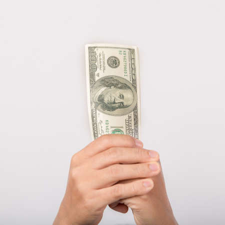 Close up of woman hand holding 100 dollar bills. success business female happy with many money banknote. Finance and economics concepts.の写真素材