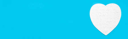 White heart shape of jigsaw puzzle pieces on blue background. concepts of problem solving, business...
