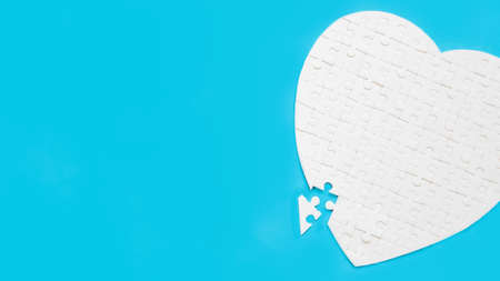 White part of jigsaw puzzle pieces on blue background. concepts of problem solving, business success, teamwork, Team playing jigsaw game incomplete, Texture photo with copy space for textの写真素材