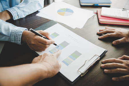Business group collaboration discussing work analysis with document financial data and marketing growth report graph in team, presentation and brainstorming to strategy plan making profit of company.の写真素材