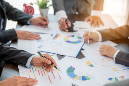 Group professional business people person working together to analyze in office, work together to discuss company financial statistics report, brainstorm ideas, and graph datum documents on the table.の写真素材