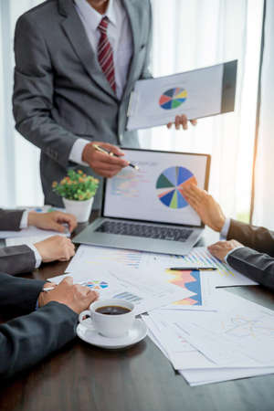 Group professional business people person working together to analyze in office, work together to discuss company financial statistics report, brainstorm ideas, and graph datum documents on the table.の写真素材