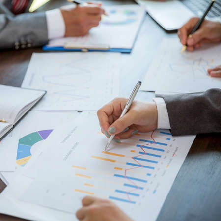 Group professional business people person working together to analyze in office, work together to discuss company financial statistics report, brainstorm ideas, and graph datum documents on the table.の写真素材
