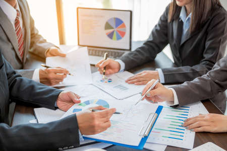 Group professional business people person working together to analyze in office, work together to discuss company financial statistics report, brainstorm ideas, and graph datum documents on the table.の写真素材