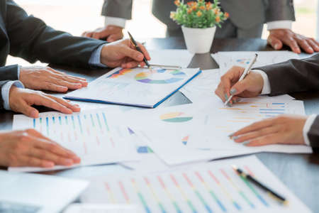 Group professional business people person working together to analyze in office, work together to discuss company financial statistics report, brainstorm ideas, and graph datum documents on the table.の写真素材