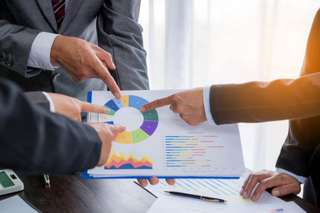 Group professional business people person working together to analyze in office, work together to discuss company financial statistics report, brainstorm ideas, and graph datum documents on the table.の写真素材
