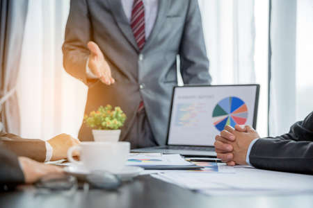 Group professional business people person working together to analyze in office, work together to discuss company financial statistics report, brainstorm ideas, and graph datum documents on the table.の写真素材