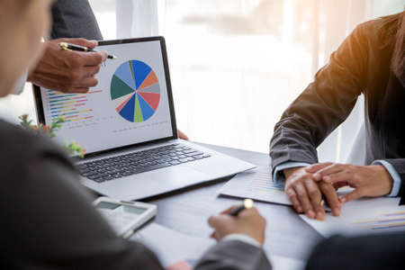 Group professional business people person working together to analyze in office, work together to discuss company financial statistics report, brainstorm ideas, and graph datum documents on the table.の写真素材