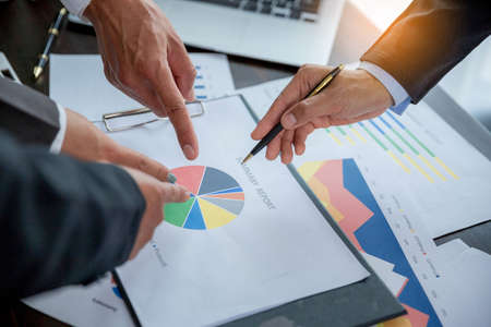 Group professional business people person working together to analyze in office, work together to discuss company financial statistics report, brainstorm ideas, and graph datum documents on the table.の写真素材