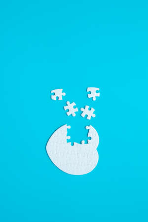 White heart shape of jigsaw puzzle pieces on blue background. concepts of problem solving, business success, teamwork, Team playing jigsaw game incomplete, Texture banner with copy space for textの写真素材