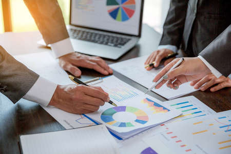 Group professional business people person working together to analyze in office, work together to discuss company financial statistics report, brainstorm ideas, and graph datum documents on the table.の写真素材