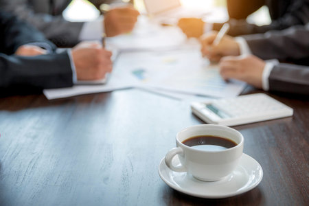 Group professional business people person working together to analyze in office, work together to discuss company financial statistics report, brainstorm ideas, and graph datum documents on the table.の写真素材
