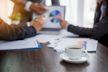 Group professional business people person working together to analyze in office, work together to discuss company financial statistics report, brainstorm ideas, and graph datum documents on the table.の写真素材