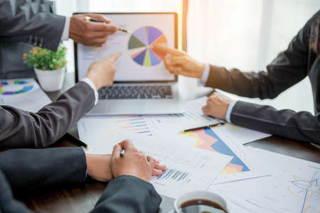 Group professional business people person working together to analyze in office, work together to discuss company financial statistics report, brainstorm ideas, and graph datum documents on the table.の写真素材