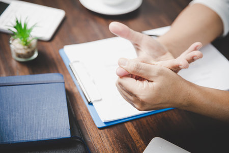 Arthritis person, finger woman ache from working in office. Concept office syndrome hand pain from occupational disease, woman having wrist pain from using laptop computer, wrist pain.の写真素材