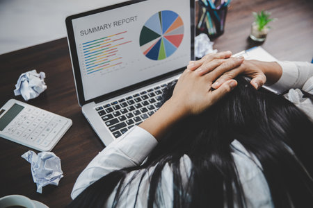 Stress business woman person from hard work, depression in office. Tired and anxious employee female with unhappy at problem job. young businesswoman sitting sad front of laptop computer on desk.の写真素材