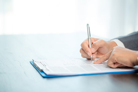 Workplace closeup person professional businesswoman sitting at desk hold pen signing or signature...