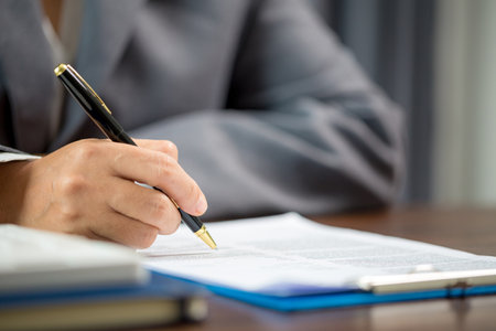 Woman home sales person is checking documents for house purchase contract before letting the customer sign contract on table is key with house model, real estate trading and insurance property conceptの写真素材