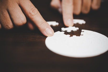 Business woman person hand with puzzle piece idea for strategy and solution. Closeup part of two white jigsaw connect together. Concept of join cooperation success teamwork-problem corporate team.の写真素材
